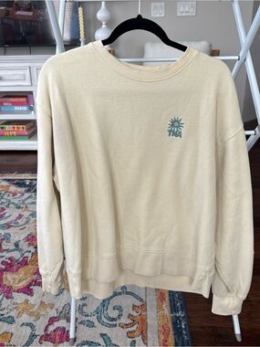 TNA Men's Cream Crewneck with Small Teal Sun Logo
